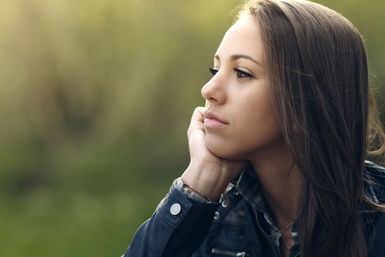 Young pensive woman contemplating.