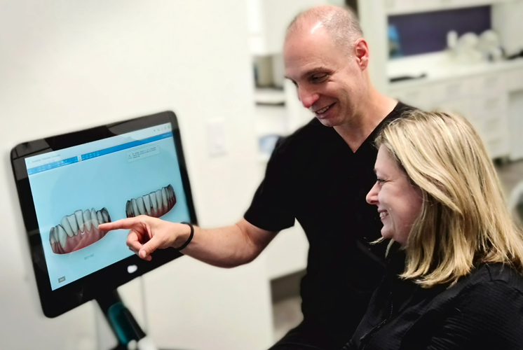 San Rafael dentist Igor Ochev shows a digital 3D image of a patient's teeth during an Invisalign consultation.