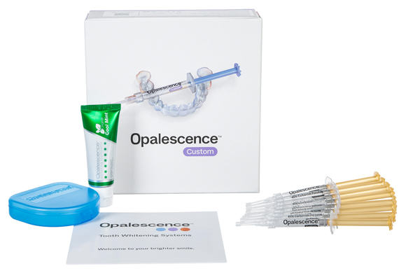Opalescence Custom Whitening patient kit box and the following shown out of the box: whitening gel, syringes, tray case, whitening toothpaste, and shade guide.